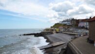 man rescued after getting trapped in rocks after he saved toddler from the sea
