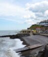 man rescued after getting trapped in rocks after he saved toddler from the sea