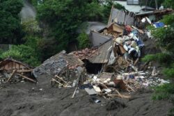 Rescuers sift through debris to find dozens in landslide-hit Japan town