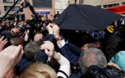 Emmanuel Macron pelted with tomatoes but he’s saved by £8,000 Kevlar umbrella