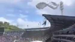 Watch as ALL FOUR parachutists in display crash into portaloos and stadium roof