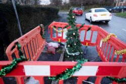 Gaping hole left in a street decorated for Christmas by fed up local