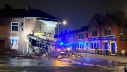 Building collapses into street after being hit by car