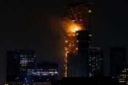 Huge fire tears through Hong Kong skyscraper raining embers on street below