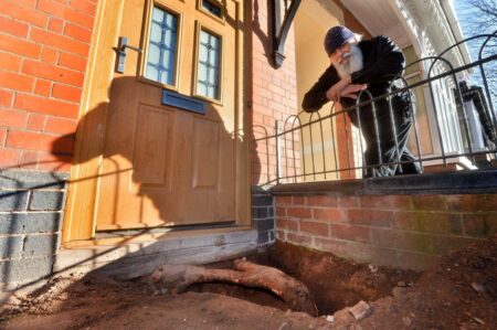 Family say huge tree root has stopped them using their front door for four years