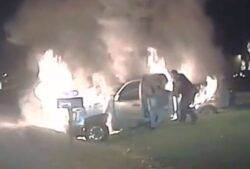 Insane moment police officer rescues woman from blazing car on edge of motorway