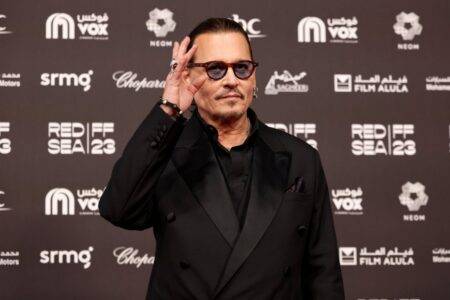 Johnny Depp resumes Hollywood life rubbing shoulders with Sharon Stone and Will Smith at A-list bash
