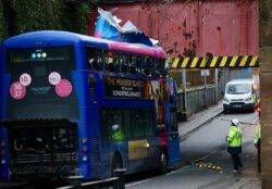 Roof ripped off double-decker bus after it crashes into bridge