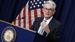 Fed holds key interest rate and warns on inflation